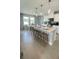 Modern kitchen features a large island with pendant lighting and seating at 6450 Horseshoe Lane Way, St Cloud, FL 34773