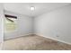 Simple bedroom with neutral carpet, a single window, and a ceiling light offering a blank canvas at 660 Egret Place Dr, Winter Garden, FL 34787
