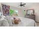 Bright bedroom with a ceiling fan, large window with view, and decor reflecting a personalized style at 660 Egret Place Dr, Winter Garden, FL 34787