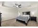 Comfortable bedroom with a ceiling fan, plush carpeting, and neutral decor, offering a relaxing retreat at 660 Egret Place Dr, Winter Garden, FL 34787