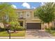 Charming two-story home with a well-manicured front yard and a spacious two-car garage and brick paver driveway at 660 Egret Place Dr, Winter Garden, FL 34787
