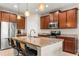 Modern kitchen features granite countertops, stainless steel appliances, and stylish pendant lighting at 660 Egret Place Dr, Winter Garden, FL 34787