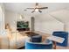 Cozy living room featuring a comfortable sofa, modern lighting, and a media center, ideal for relaxation and entertainment at 660 Egret Place Dr, Winter Garden, FL 34787
