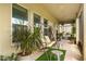 Relaxing covered patio featuring a swing seat, plants, and decorative elements at 660 Egret Place Dr, Winter Garden, FL 34787