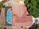 Overhead shot of the house with a screened-in pool, set amidst a mix of verdant lawn and surrounding vegetation at 6630 Abeydon Ct, Orlando, FL 32818