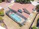 The backyard features a lovely screened pool and patio area, complete with a well-kept roof and surrounding lawn at 6630 Abeydon Ct, Orlando, FL 32818