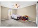 Bedroom with a bed, ceiling fan, and a window with white curtains at 6630 Abeydon Ct, Orlando, FL 32818