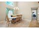 Elegant dining room featuring a modern chandelier, large windows, and stylish decor at 6630 Abeydon Ct, Orlando, FL 32818