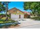 Charming two-story home features a brick-accented facade and a spacious two-car garage at 6630 Abeydon Ct, Orlando, FL 32818