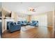 Comfortable living room with blue sofas, fireplace, and wood flooring at 6630 Abeydon Ct, Orlando, FL 32818