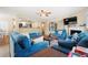 Inviting living room showcasing blue sofas, fireplace, and open layout to kitchen at 6630 Abeydon Ct, Orlando, FL 32818