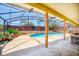 Screened in pool with concrete patio and planters surrounding the area at 6630 Abeydon Ct, Orlando, FL 32818