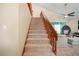 Carpeted staircase with wooden banister, leading to a room with a hanging chair at 6630 Abeydon Ct, Orlando, FL 32818