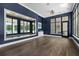 Bright fitness center featuring hardwood floors, mirrors, and an exit leading to an outdoor pool at 7155 Cow Prairie Rd, St Cloud, FL 34773