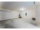 Spacious garage with concrete floor and cinder block walls, featuring a water heater and electrical panel at 7155 Cow Prairie Rd, St Cloud, FL 34773