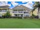 Spacious green backyard with a wrought iron fence and lush tropical landscaping at 7388 Gathering Ct, Reunion, FL 34747