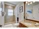 Bathroom with a glass shower, a toilet, tile flooring and a wood vanity with a granite countertop at 7388 Gathering Ct, Reunion, FL 34747