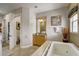 Bathroom featuring a soaking tub, vanity, and window with blind at 7388 Gathering Ct, Reunion, FL 34747
