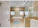 Bathroom featuring a soaking tub, walk-in shower, and transom windows at 7388 Gathering Ct, Reunion, FL 34747