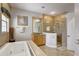 Bathroom with a soaking tub, walk-in shower, and vanity at 7388 Gathering Ct, Reunion, FL 34747