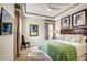 Comfortable bedroom showcases soft, neutral walls, tray ceiling and colorful striped valances, plus decorative framed wall art at 7388 Gathering Ct, Reunion, FL 34747