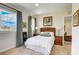 Cozy bedroom with two windows and patterned curtains has two night stands with lamps and decorative wall art at 7388 Gathering Ct, Reunion, FL 34747