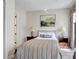 Bedroom with decorative lamps, and framed painting features patterned curtains and an ensuite bathroom at 7388 Gathering Ct, Reunion, FL 34747