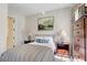 Bedroom with two end tables and lamps features a beautifully framed painting on the wall and patterned curtains at 7388 Gathering Ct, Reunion, FL 34747