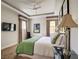 Bright bedroom featuring neutral walls, tray ceiling with ceiling fan, and colorful striped window treatments at 7388 Gathering Ct, Reunion, FL 34747
