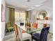 Stylish dining room with a glass table, unique lighting, and elegant decor at 7388 Gathering Ct, Reunion, FL 34747