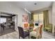 Modern dining room with views to living space, stylish light fixture and ample seating at 7388 Gathering Ct, Reunion, FL 34747
