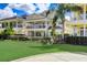 A covered porch, tall palms, and privacy landscaping offers the perfect curb appeal at 7388 Gathering Ct, Reunion, FL 34747