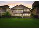 Beautiful view of two-story home featuring a well manicured lawn at 7388 Gathering Ct, Reunion, FL 34747