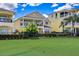 A bright, meticulously kept home offers an outdoor patio, green space, and privacy fence at 7388 Gathering Ct, Reunion, FL 34747