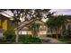 Inviting exterior of a well-maintained home with lush landscaping and a stately entrance at 7388 Gathering Ct, Reunion, FL 34747