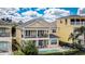 Exterior rear view showcasing a private pool and covered patio at 7388 Gathering Ct, Reunion, FL 34747