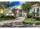 Charming two-story home with manicured landscaping, a paved driveway, and a welcoming entrance at 7388 Gathering Ct, Reunion, FL 34747