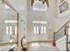 Bright foyer with mosaic tile, staircase, and a large mirror reflecting natural light, creating an inviting entrance at 7388 Gathering Ct, Reunion, FL 34747