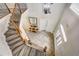 Dramatic foyer with tile flooring, wood staircase, and view of front entry at 7388 Gathering Ct, Reunion, FL 34747