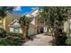 Charming two-story home featuring a paver driveway, two car garage and lush landscaping at 7388 Gathering Ct, Reunion, FL 34747