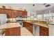 Bright kitchen with granite counters, stainless appliances, and tile flooring at 7388 Gathering Ct, Reunion, FL 34747
