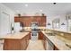 Bright kitchen features stainless appliances, granite counters and tile floors at 7388 Gathering Ct, Reunion, FL 34747