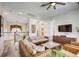 Open living room with comfortable seating, TV, and ceiling fan at 7388 Gathering Ct, Reunion, FL 34747