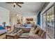 Spacious living room with an oversized sectional sofa and large windows offering outdoor views, creating a comfortable atmosphere at 7388 Gathering Ct, Reunion, FL 34747