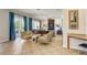 Spacious living room with stylish striped seating, stone fireplace, and seamless access to outdoor patio through sliding doors at 7388 Gathering Ct, Reunion, FL 34747