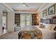 Bedroom with a ceiling fan, framed artwork, and balcony access at 7388 Gathering Ct, Reunion, FL 34747