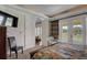 Bedroom featuring a seating area, French doors, and balcony access at 7388 Gathering Ct, Reunion, FL 34747