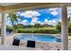 Stunning view of the private pool and lush landscaping from the covered patio at 7388 Gathering Ct, Reunion, FL 34747