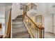 Staircase features wood treads, iron spindles, wood banister and decorative lighting at 7388 Gathering Ct, Reunion, FL 34747