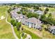 Scenic aerial view capturing a residential building amidst lush greenery and golf course features, showcasing community living at 7649 Heritage Crossing Way # 302, Reunion, FL 34747
